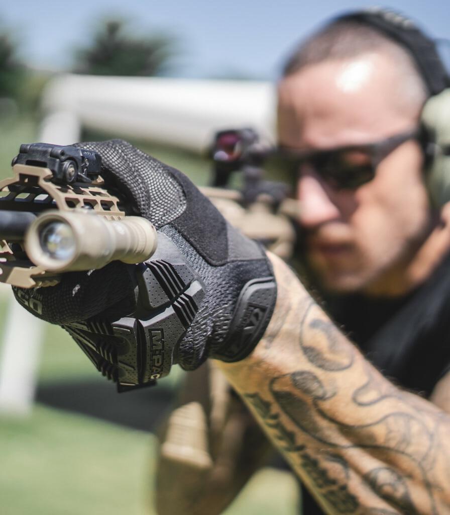 Versatile Outdoor Tactical Gloves: Reliable Protection for Any Activity with a man shooting a gun outside 