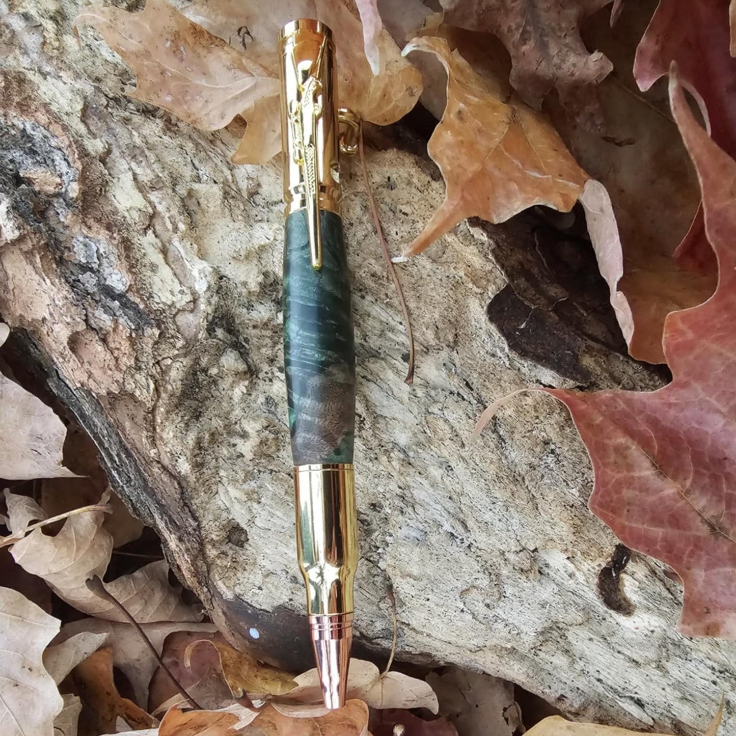 Full view of the green and gold bolt action pen